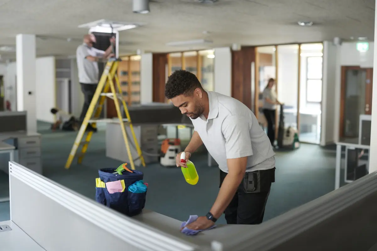 Office cleaning crew at work with supplies.