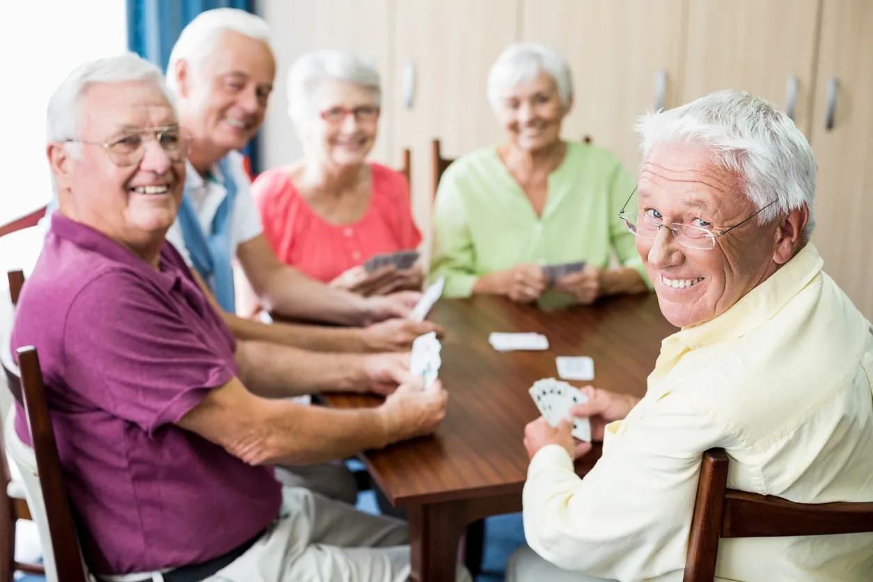 Seniors enjoying a card game together at a table.